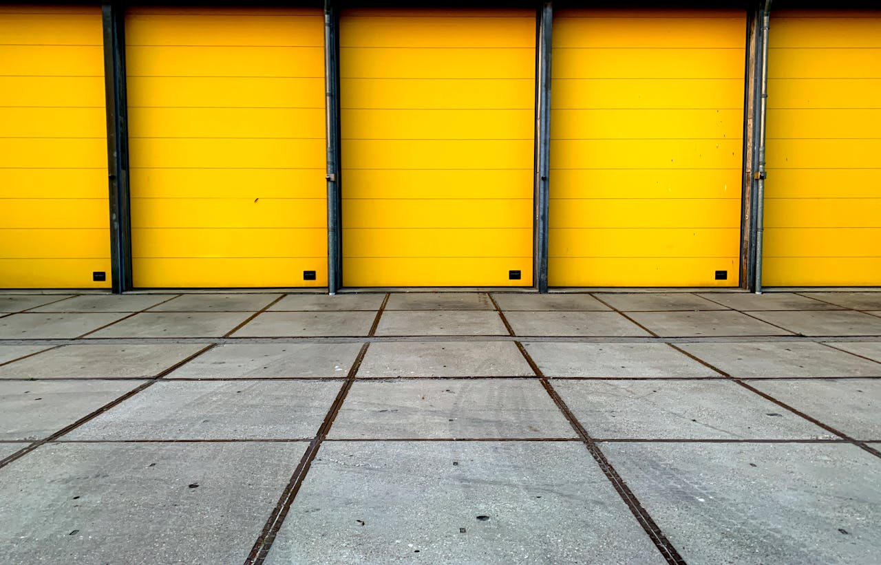 Bold yellow garage doors in an urban landscape showcasing symmetry and geometric design.